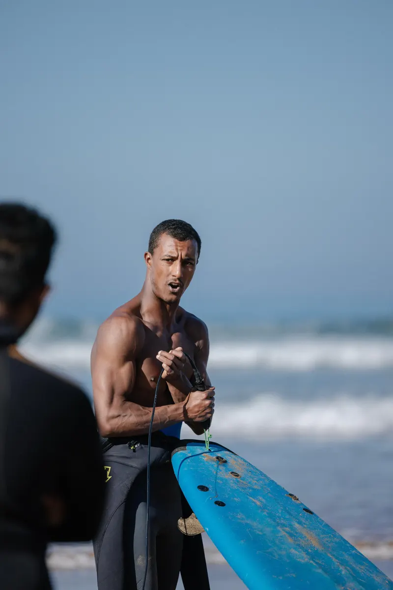 Chafik coaching from the shore with a board in hand