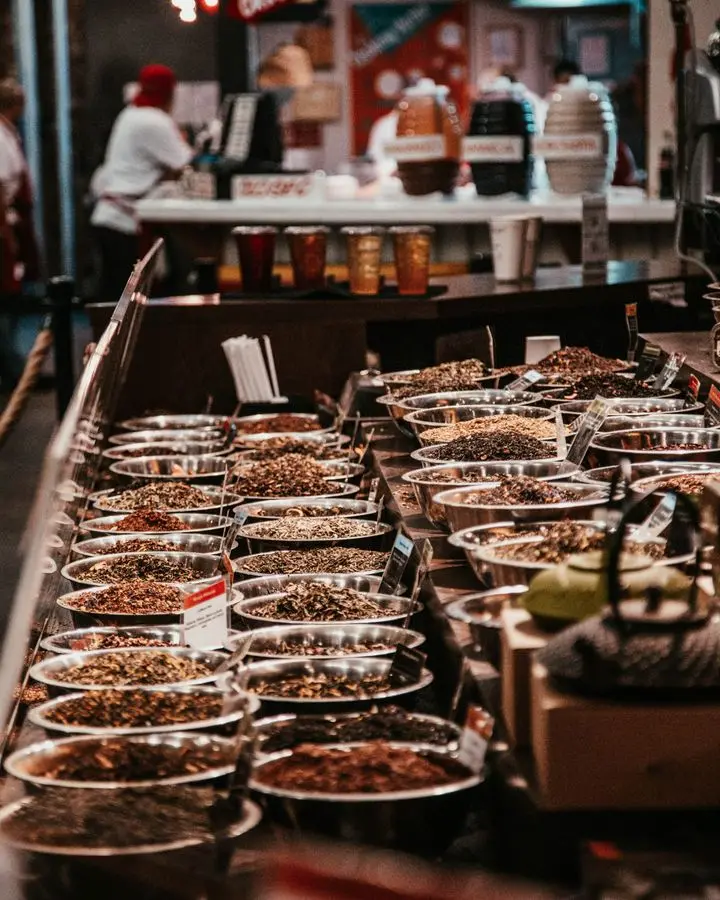 Colorful spice stall in New York City market, showcasing diverse aromatic herbs and spices.